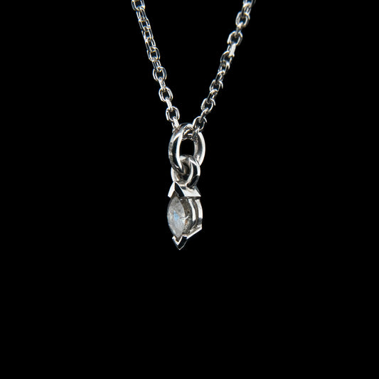 Silver necklace with a pendant on a black background