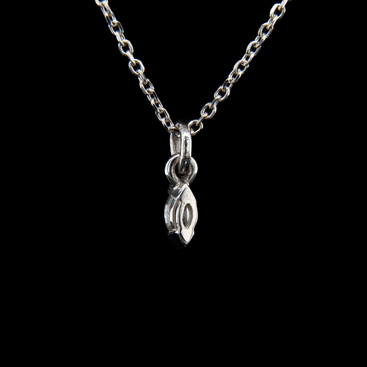 Silver necklace with a pendant on a black background