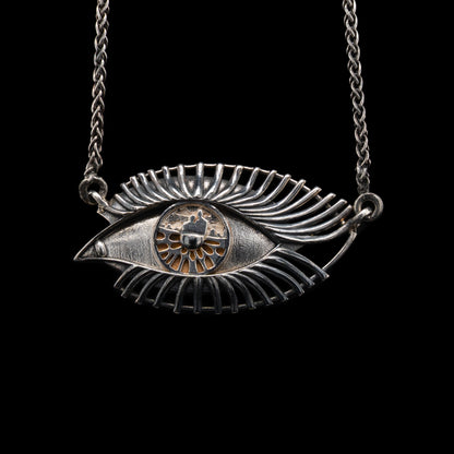 Silver eye-shaped pendant necklace on a black background