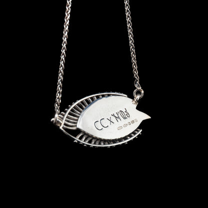 Silver necklace with a leaf-shaped pendant on a black background