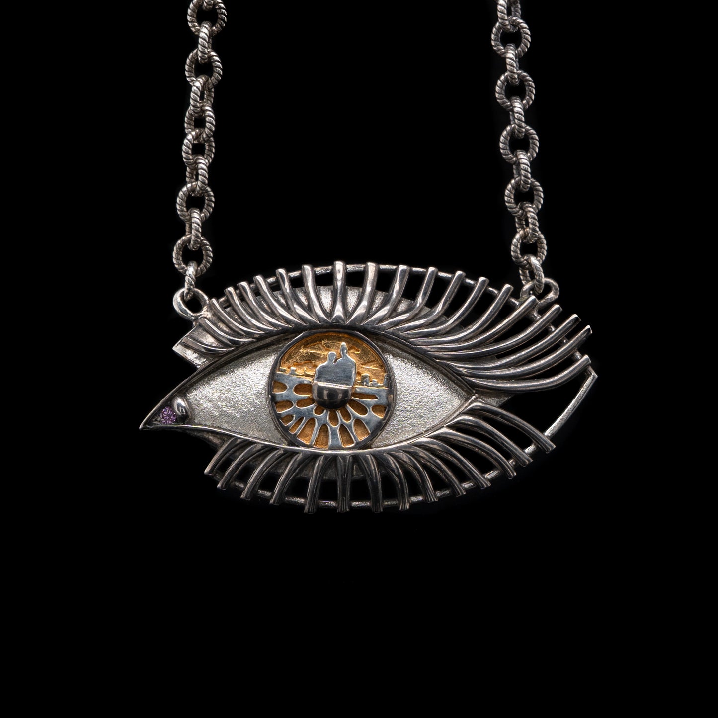 Silver eye-shaped pendant necklace on a black background