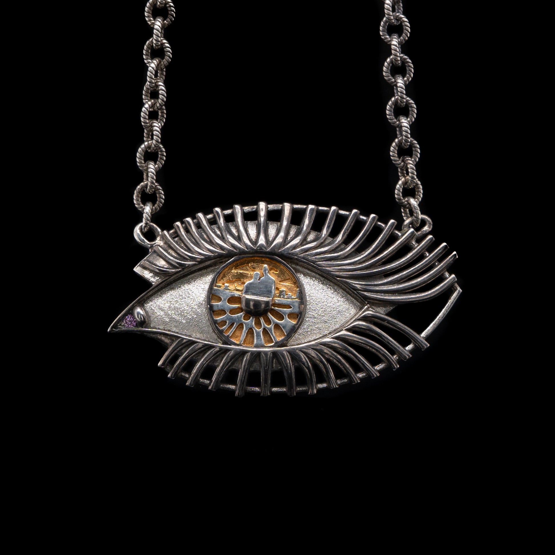 Silver eye-shaped pendant necklace on a black background