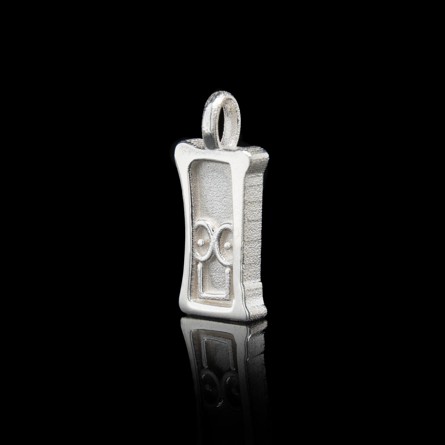 Everyman sterling silver smile head charm pendant with a unique design on a black background