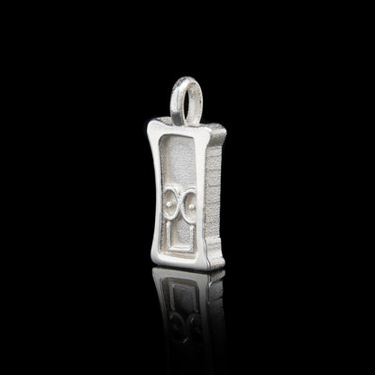 Everyman sterling silver smile head charm pendant with a unique design on a black background