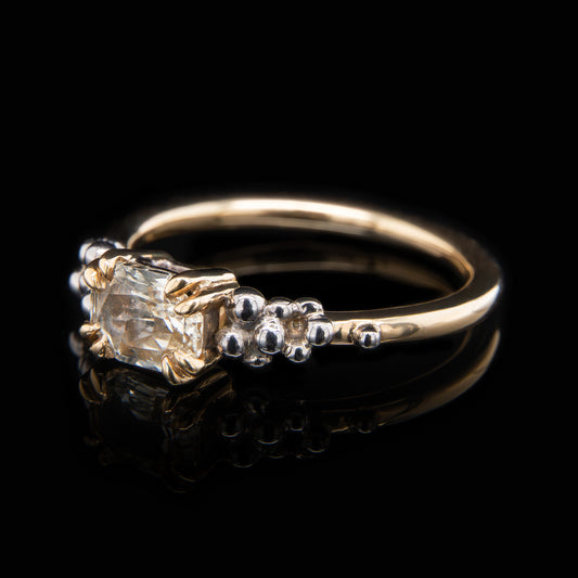 Gold ring with a 18ct yellow sapphire on a black background