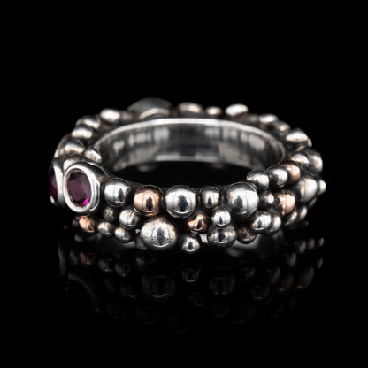 side view of bubble Silver ring with grape garnets gemstones on a black background